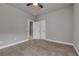 Neutral-toned carpeted bedroom features a ceiling fan and closet at 1179 Bennett Creek Overlook, Suwanee, GA 30024