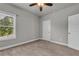 Neutral bedroom featuring carpet floors, ceiling fan, and natural light from a window at 1179 Bennett Creek Overlook, Suwanee, GA 30024