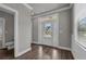 Bright entryway with decorative door, neutral paint, and wood-look floors at 1179 Bennett Creek Overlook, Suwanee, GA 30024