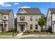 Charming two-story brick home with a covered front porch and professionally landscaped front yard at 1179 Bennett Creek Overlook, Suwanee, GA 30024