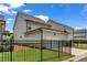View of modern home with a two-car garage and fenced front yard at 1179 Bennett Creek Overlook, Suwanee, GA 30024