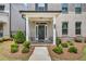 Inviting front porch with classic columns, brick accents, and a welcoming entrance at 1179 Bennett Creek Overlook, Suwanee, GA 30024