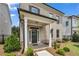 Welcoming front porch featuring brick accents, manicured bushes, and a stylish front door at 1179 Bennett Creek Overlook, Suwanee, GA 30024