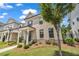 Well-manicured front yard featuring a tidy lawn, mulch beds, and blooming rose bushes at 1179 Bennett Creek Overlook, Suwanee, GA 30024