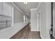 Long hallway featuring wood floors, white trim, and natural lighting at 1179 Bennett Creek Overlook, Suwanee, GA 30024