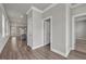 Hallway featuring wood-look floors, white trim, and neutral paint at 1179 Bennett Creek Overlook, Suwanee, GA 30024