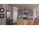 Charming kitchen featuring gray cabinets, stainless steel appliances, white backsplash and quartz countertops at 1179 Bennett Creek Overlook, Suwanee, GA 30024