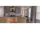 Bright kitchen features gray cabinets, gold fixtures, stainless steel appliances, and a stylish center island at 1179 Bennett Creek Overlook, Suwanee, GA 30024