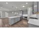 Open-concept kitchen with an island, stainless steel appliances, and modern gray cabinetry at 1179 Bennett Creek Overlook, Suwanee, GA 30024