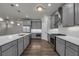 Well-lit kitchen featuring stainless steel appliances, gray cabinetry, hardwood floors and a spacious white countertop island at 1179 Bennett Creek Overlook, Suwanee, GA 30024