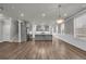 Open-concept living area flowing into a modern kitchen with stainless steel appliances at 1179 Bennett Creek Overlook, Suwanee, GA 30024