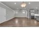 Large living space with an open floor plan, modern lighting, and access to the kitchen at 1179 Bennett Creek Overlook, Suwanee, GA 30024