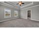 Spacious main bedroom with carpet, tray ceiling, and community views at 1179 Bennett Creek Overlook, Suwanee, GA 30024