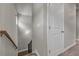 Well-lit stairwell with hardwood stairs, wood railing, neutral walls and white trim at 1179 Bennett Creek Overlook, Suwanee, GA 30024