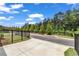 Street view of a modern home with lush landscaping and a fenced yard at 1179 Bennett Creek Overlook, Suwanee, GA 30024
