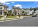 Street view of beautiful two-story homes with manicured lawns, sidewalks, and lush landscaping at 1179 Bennett Creek Overlook, Suwanee, GA 30024