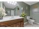Bathroom features a vanity with a white countertop, decorative flowers and a toilet at 2520 Hartford Dr, Ellenwood, GA 30294