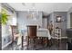 Dining room features a chandelier, dining table with chairs, and dark marble flooring at 2520 Hartford Dr, Ellenwood, GA 30294
