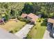 Aerial front view of a home with a brown roof, mature trees, manicured lawn and a long driveway at 2520 Hartford Dr, Ellenwood, GA 30294