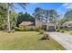 Charming home with well-manicured lawn, lush landscaping, and attached garage at 2520 Hartford Dr, Ellenwood, GA 30294