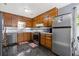 Well-lit kitchen with wood cabinetry, stainless steel appliances, and sleek black marble floors at 2520 Hartford Dr, Ellenwood, GA 30294