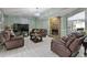 Inviting living room with cozy leather seating, stone fireplace, and open floor plan at 2520 Hartford Dr, Ellenwood, GA 30294