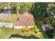 Aerial view of a well-maintained tan home with a shed, brown roof, manicured lawn, and mature trees at 2520 Hartford Dr, Ellenwood, GA 30294