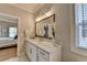 Elegant bathroom with marble countertops, white cabinetry, and a large framed mirror at 3364 Old Concord Se Rd, Smyrna, GA 30082