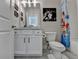 Well-lit bathroom with a white vanity cabinet, modern fixtures, framed star wars art, and a shower with curtain at 3364 Old Concord Se Rd, Smyrna, GA 30082