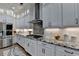 Modern kitchen featuring sleek appliances, granite counters, and a stylish backsplash at 3364 Old Concord Se Rd, Smyrna, GA 30082