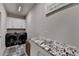 Functional laundry room with granite counters, ample storage, and modern appliances at 3364 Old Concord Se Rd, Smyrna, GA 30082