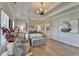 Elegant primary suite with a four-poster bed, sitting area, and tray ceiling with fan at 3364 Old Concord Se Rd, Smyrna, GA 30082