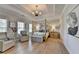 Spacious main bedroom with tray ceiling, four-poster bed, sitting area, and natural light at 3364 Old Concord Se Rd, Smyrna, GA 30082