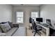 Bright home office with a comfortable couch, desk, computer, and large windows at 3364 Old Concord Se Rd, Smyrna, GA 30082