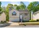 Two-story home featuring a stone accent wall, attached two-car garage, and well-maintained front yard at 3487 Creekview Dr, Rex, GA 30273