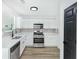 Well-lit kitchen showcasing white cabinets, stainless steel appliances, new countertops, and wood-look flooring at 3487 Creekview Dr, Rex, GA 30273