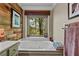 Bright bathroom with a large tub next to a window offering a view of the landscape at 403 S River Farm Dr, Alpharetta, GA 30022