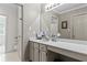Bathroom vanity with white countertop and cabinets, with toilet through doorway at 403 S River Farm Dr, Alpharetta, GA 30022
