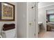 Bathroom with toilet, sink/vanity, and view into bedroom through a doorway at 403 S River Farm Dr, Alpharetta, GA 30022