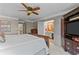 Bedroom with ceiling fan and doorway leading to updated bathroom with wood accent wall at 403 S River Farm Dr, Alpharetta, GA 30022