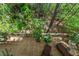 Aerial view of backyard deck with lounge chairs surrounded by towering trees, an oasis of serenity at 403 S River Farm Dr, Alpharetta, GA 30022