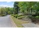 Well-manicured entrance to Carriage Homes at River Farm, surrounded by lush landscaping at 403 S River Farm Dr, Alpharetta, GA 30022
