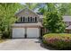 Charming two-story home featuring a two-car garage, well-maintained landscaping, and inviting curb appeal at 403 S River Farm Dr, Alpharetta, GA 30022