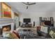 Inviting living room with fireplace, hardwood floors, large windows and a comfortable leather couch at 403 S River Farm Dr, Alpharetta, GA 30022