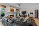Bright living room showcasing hardwood floors, fireplace, large windows, and comfortable leather couch at 403 S River Farm Dr, Alpharetta, GA 30022