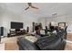 Spacious living room with hardwood floors, large leather couch, TV, and neutral walls at 403 S River Farm Dr, Alpharetta, GA 30022