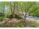 The exterior of the home includes stone steps and garden featuring mature trees and lush landscaping at 403 S River Farm Dr, Alpharetta, GA 30022