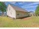 Manicured lawn leading to a home with well-placed windows and a covered porch at 704 Williamsburg Ct, Villa Rica, GA 30180