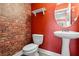 Stylish powder room with unique brick wall and modern sink at 704 Williamsburg Ct, Villa Rica, GA 30180