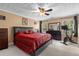 Bedroom featuring a ceiling fan, windows, and dark wood furniture at 704 Williamsburg Ct, Villa Rica, GA 30180